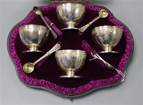 A cased set of 4 Victorian engraved silver salts and four spoons, London, 1882.